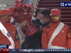 翟志刚下飞机后，和手捧鲜花的儿子拥抱