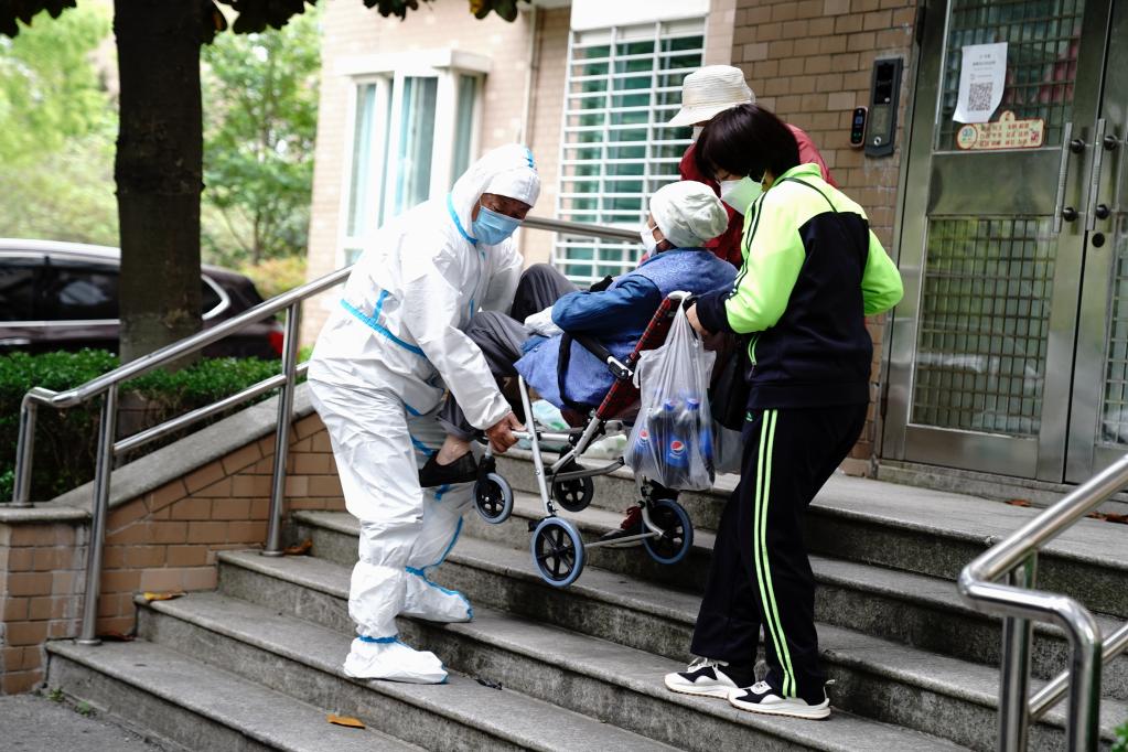 古美社区卫生服务中心司机冯守光协助家属把血透患者抬下台阶。新华社记者 张建松 摄
