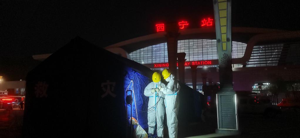 国网青海电力公司工作人员正为设在西宁火车站的核酸检测点接入临时电源。(受访者供图)
