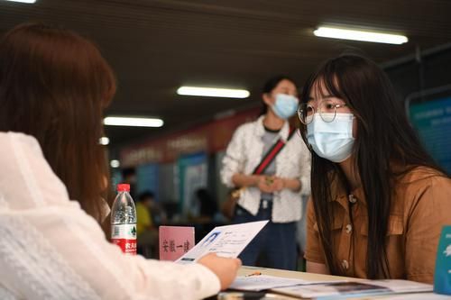 5月17日,在合肥学院内,求职者(右)向用人单位工作人员了解招聘信息。新华社记者 张端 摄